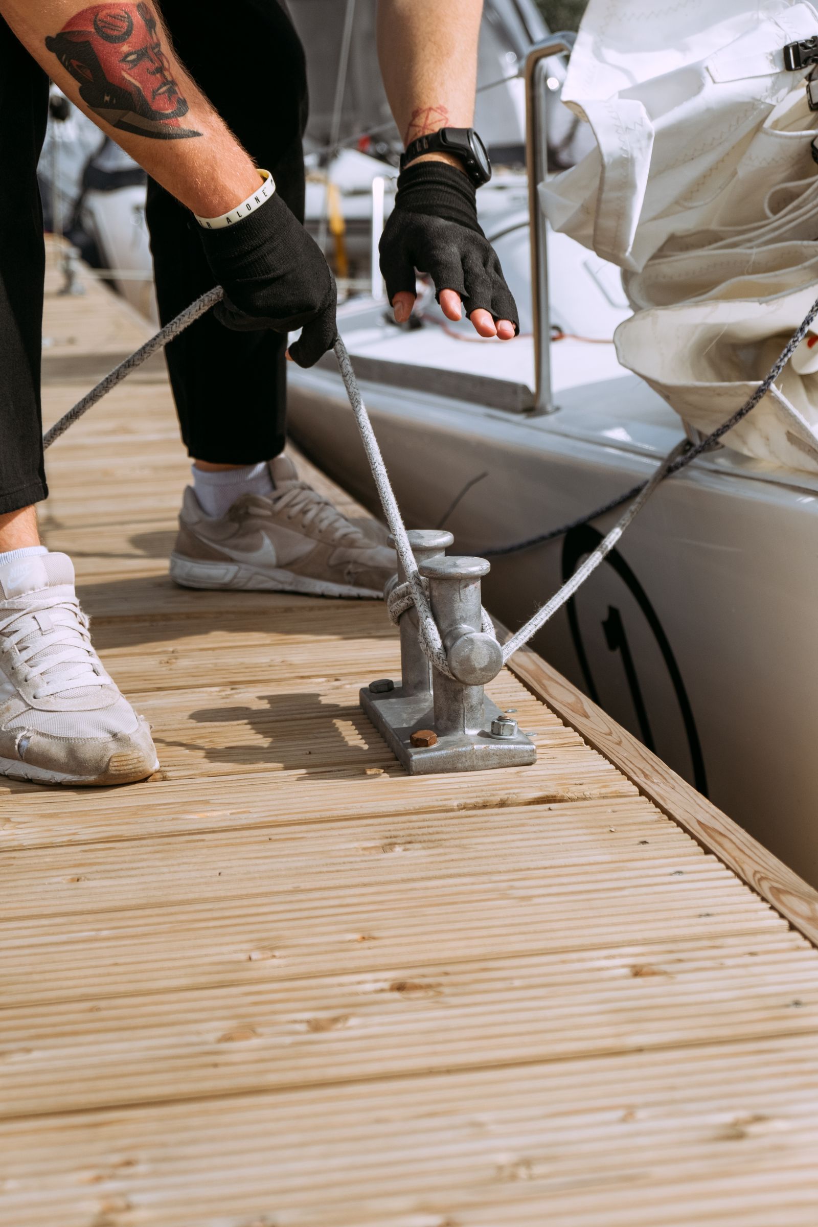 Sailing yacht being secured alongside a marina berth
